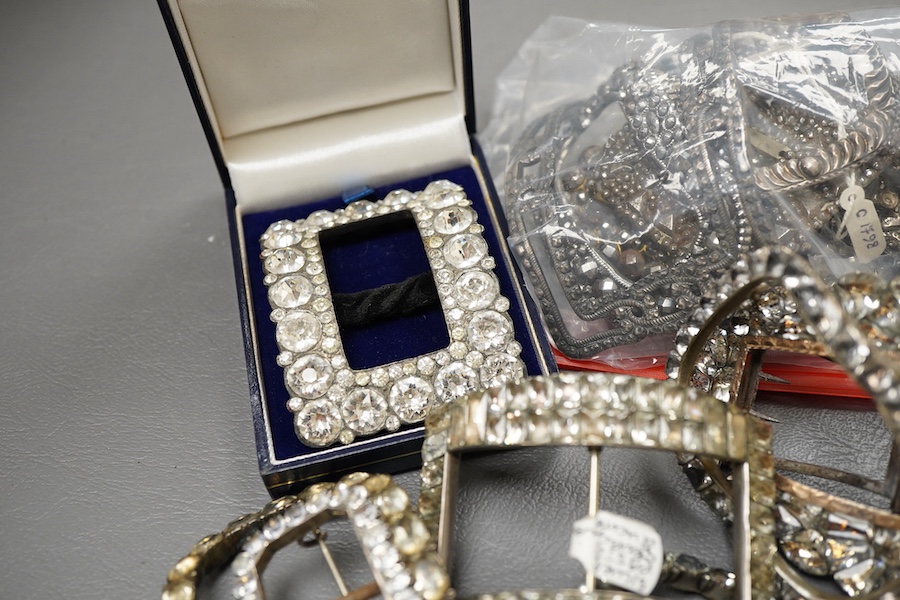 A large collection of buckles, 18th-19th century, of oval and rectangular outline, set with pastes or cut steel, mostly mounted in steel, a minority in silver, some with later brooch fittings